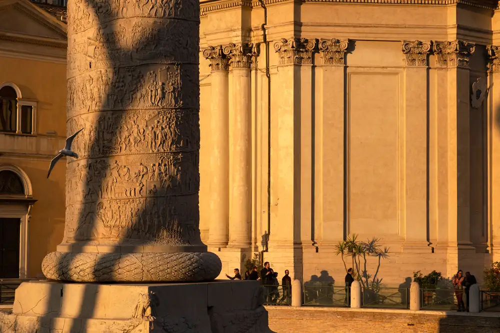 Trajan's Column base with spiral relief carvings at golden hour, Rome